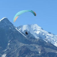 man paragliding with mountain in background